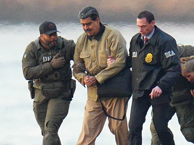 Nicolas Maduro and his wife, Cilia Flores, are seen in handcuffs after landing at a Manhat