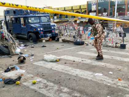 A soldier inspects the aftermath of Monday's bomb blast at a market in Maiduguri, Nig