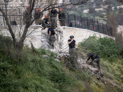 Security forces cordon the area after a piece of a missile fell near the walls of the Old
