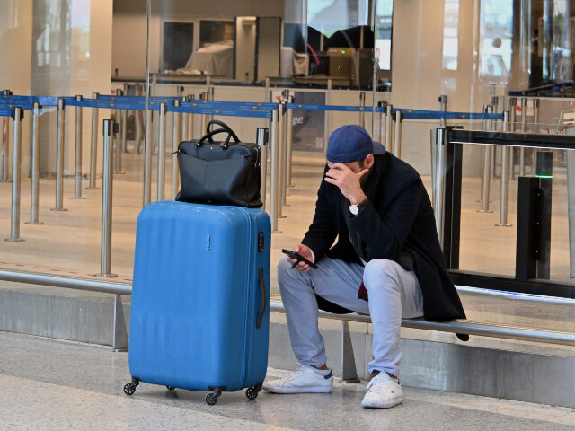 Passengers are stranded in the terminal following prolonged flight cancellations after the