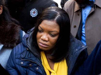 In this Nov. 25, 2019 file photo, Tova Noel, center in yellow blouse, a federal jail guard