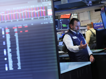 Traders work on the floor of the New York Stock Exchange during morning trading on March 6
