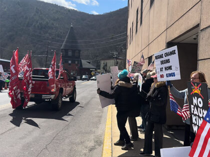 A Trump supporter in a big, red truck trolled leftist "No Kings" protesters in 
