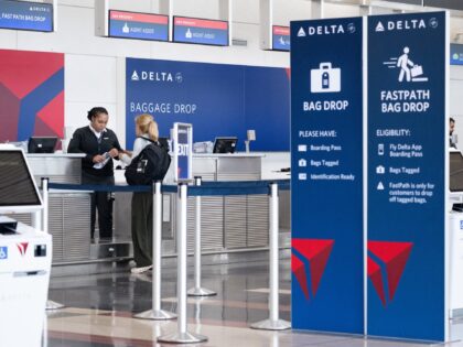 Passengers check in for a flight with Delta Air Lines at Ronald Reagan Washington National