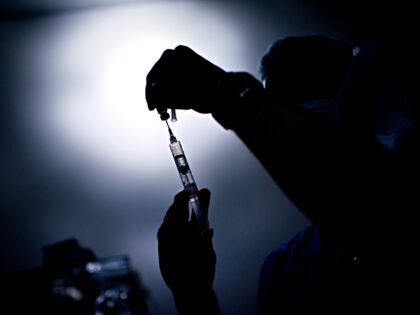 A doctor draws medicine into a syringe during a kidney transplant at Johns Hopkins Hospita