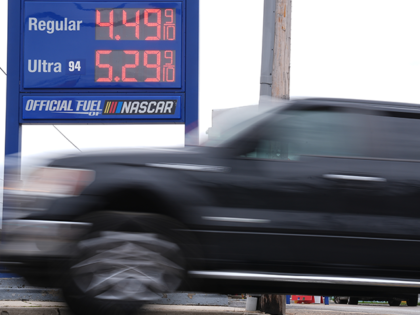 A vehicle passes a gasoline price board at a filling station in Philadelphia, Friday, Marc