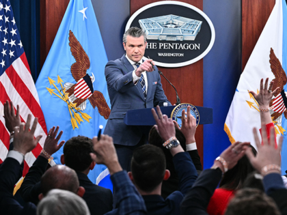 TOPSHOT - US Secretary of Defense Pete Hegseth takes questions during a news conference at