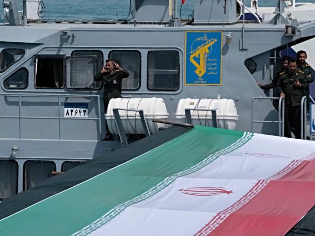 Islamic Revolutionary Guard Corps (IRGC) Navy military personnel are standing on a warship