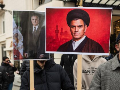 MADRID, SPAIN - 2026/01/22: A man holds a placard with the picture of Spanish Prime Minist
