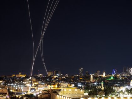 Rocket trails from an interception by Israel's Iron Dome missile defence system are pictur