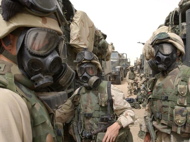 TOPSHOT - US Marines from the 2nd battalion/8th Marines wear their gas masks 21 March 2003