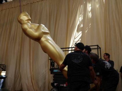 Workers carry an Oscar statue ahead of the 98th Annual Academy Awards outside the Dolby Th