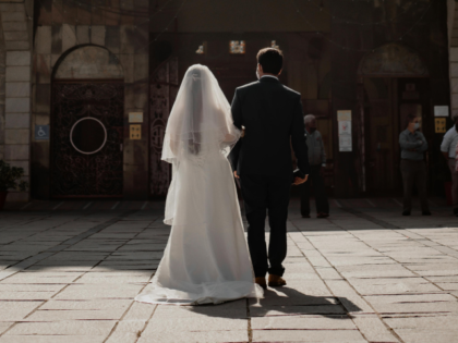Rear view of bride and groom at church