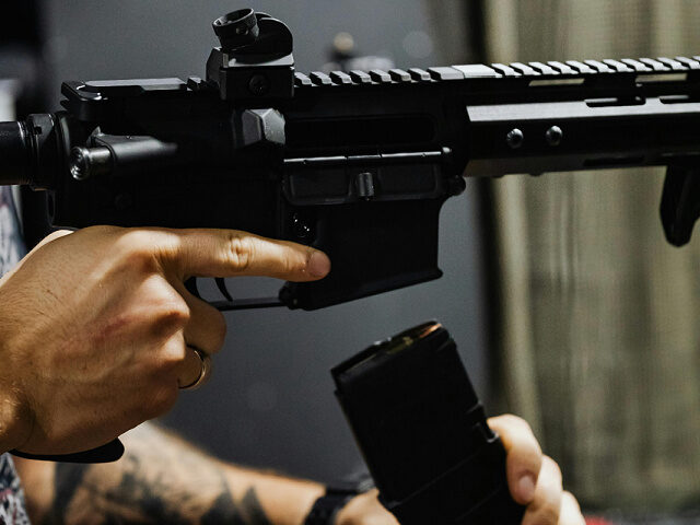 A Person Reloading a Rifle