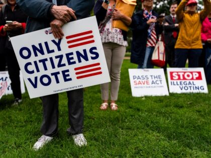 save-act-signs-getty WASHINGTON, DC - SEPTEMBER 10: Attendees listen to Rep. Chip Roy (R-TX) speaking at a &quo