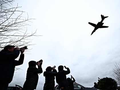 Plane spotters watch a US Air Force B-1 Lancer bomber taking off from RAF Fairford in sout