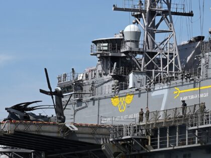 Personnel are seen on board the US Navy’s USS Tripoli (LHA-7) amphibious assault ship du