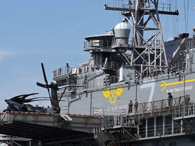 Personnel are seen on board the US Navy’s USS Tripoli (LHA-7) amphibious assault ship du
