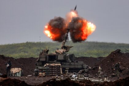 An Israeli howitzer fires rounds towards southern Lebanon from a position in the upper Gal
