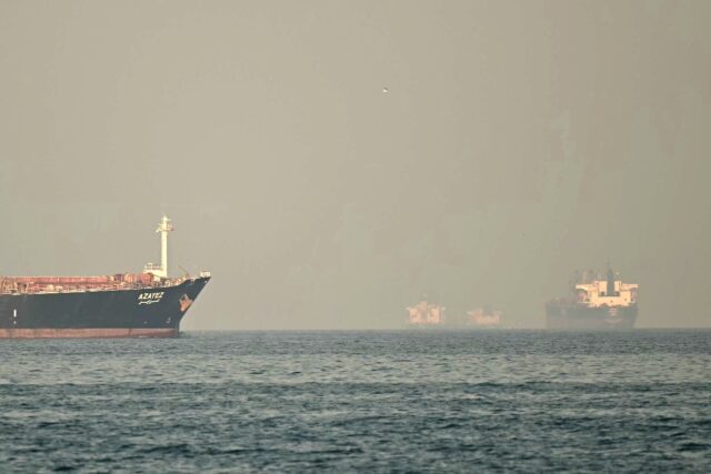 Cargo ships and tankers ply the Strait of Hormuz