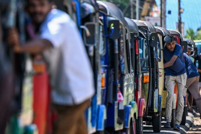 Drivers queue to refuel rickshaws at a fuel station on the outskirts of the Sri Lankan cap