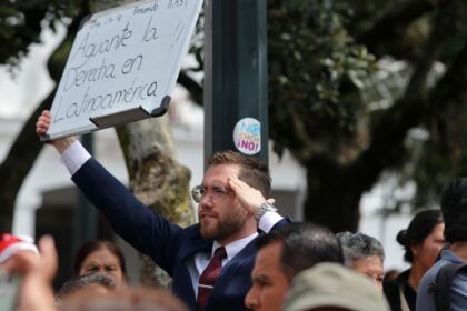 A man holds a sign reading "Long live the right wing in Latin America" as Chile&