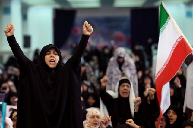 Iranian Shia women shout slogans during Eid al-Fitr prayers, marking the end of the Muslim