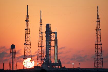 NASA's Artemis II Space Launch System (SLS) rocket and Orion spacecraft at sunrise at