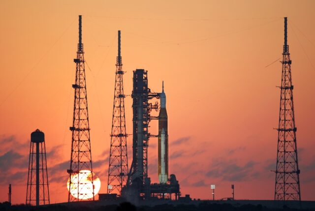 NASA's Artemis II Space Launch System (SLS) rocket and Orion spacecraft at sunrise at
