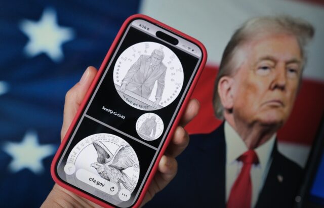 A phone displaying the commemorative gold coin featuring Trump to mark America's 250t