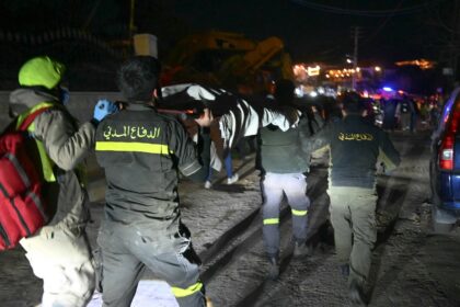 Rescuers carry a victim of an Israeli airstrike in the town of Aramoun, south of Beirut
