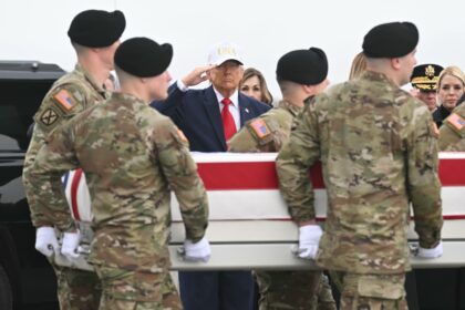 US President Donald Trump salutes as the remains of Sergeant First Class Noah Tietjens, ki