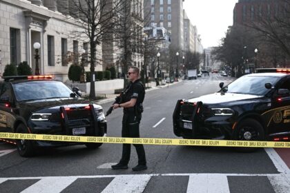 A US Secret Service agent stands watch after a vehicle smashed a security barricade near t