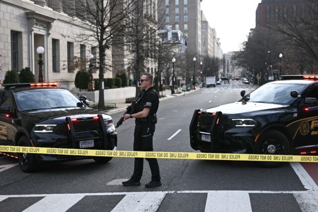 A US Secret Service agent stands watch after a vehicle smashed a security barricade near t