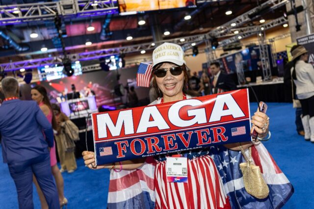 A woman shows off MAGA-branded merchandise at the Conservative Political Action Conference