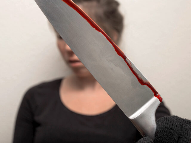 woman holding bloody knife