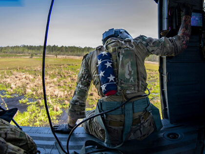 An Air Force special missions aviator prepares to land in an HH-60W Jolly Green II at Mood