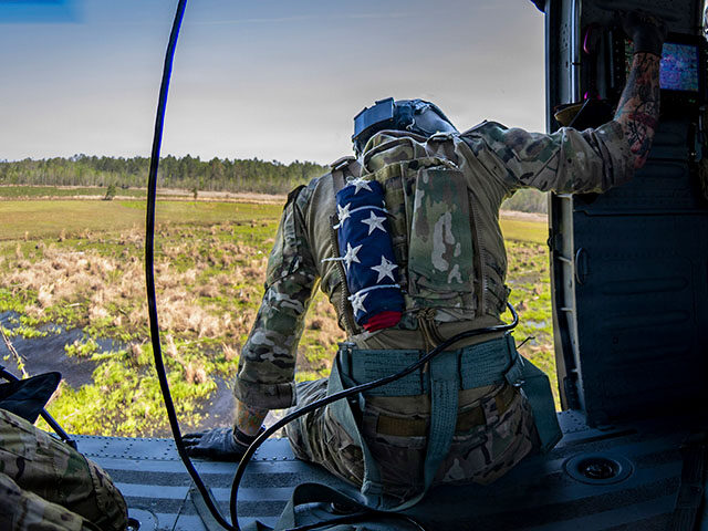 An Air Force special missions aviator prepares to land in an HH-60W Jolly Green II at Mood