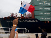 Title: Panama Canal Expansion Image ID: 16178610948077 Article: A spectator waves Panama f
