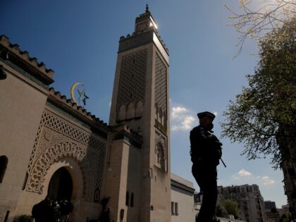 A policeman patrols outside the Paris mosque during the first day of the holy fasting mont