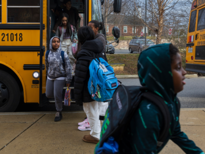 Rock Creek Forest Elementary School students exit a diesel bus before attending school, Fr