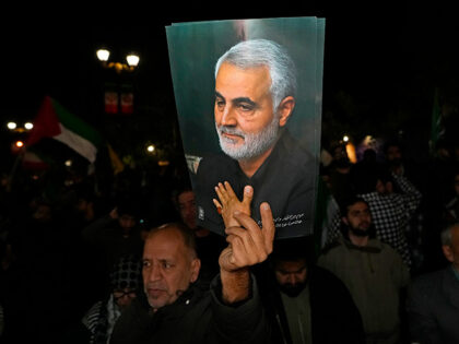 Title: Iran Mideast Tensions Image ID: 24105023694354 Article: A demonstrator holds up a p
