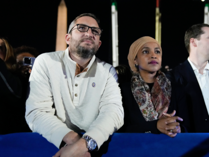 Rep. IIhan Omar, D-MN., center, and her husband Tim Mynett, left, listening to Democratic