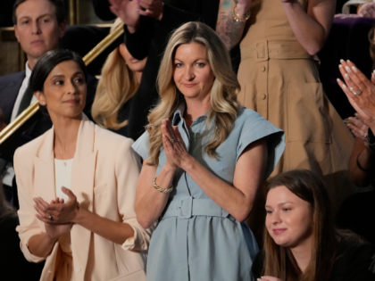 January Littlejohn of Tallahassee, Fla., center, stands as President Donald Trump addresse