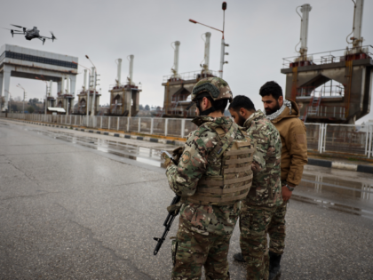 Syrian army soldiers fly a drone after Syrian government troops took control of the area f
