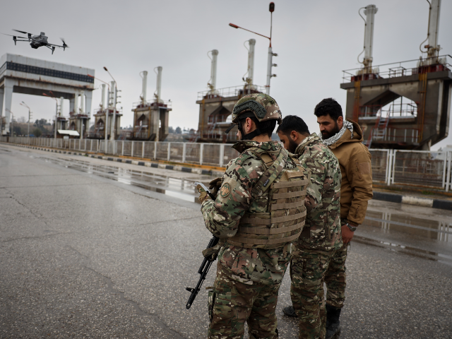 Syrian army soldiers fly a drone after Syrian government troops took control of the area f