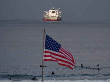 Title: APTOPIX Iran US Oil California Image ID: 26063618061288 Article: Surfers wait for w