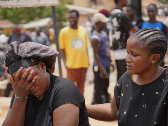 Women mourn the death of a family member following an attack by gunmen in Gari Ya Waye com