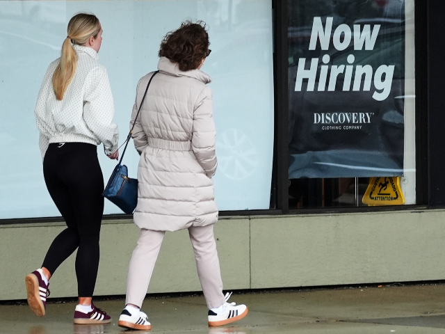 Now hiring sign is displayed at a retail store, in Arlington Heights, Ill., Thursday, Apri