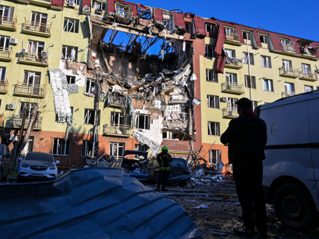 Russia Ukraine War A rescue worker walks in front of residential building which was heavily damaged after a R